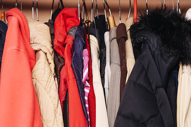 istock Various jackets hanging on hangers. Colorful winter clothes in wardrobe. Different types of coats and fabrics. 2225508931