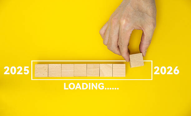 istock Loading new year 2026 with hand putting wood cube in progress bar 2225510070