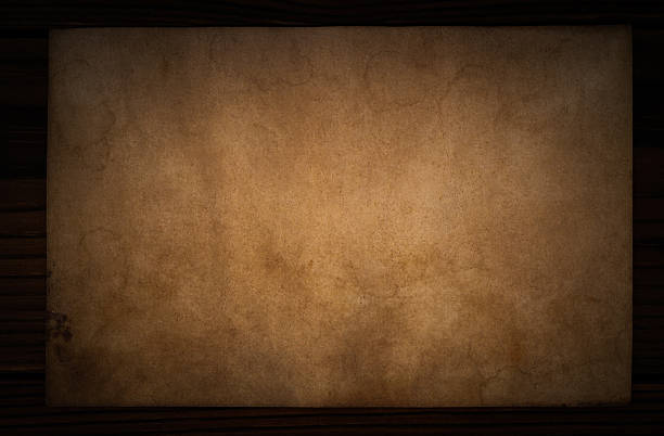 Aged dirty paper on wooden table