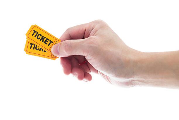 istock Hand holding two yellow cinema tickets on white background 2225510269