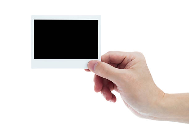 istock Human hand holding blank instant photo card on white background 2225510280