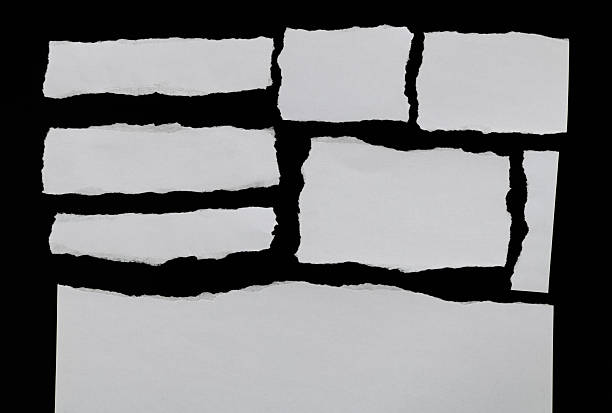 istock Pieces of torn paper on black background 2225510477