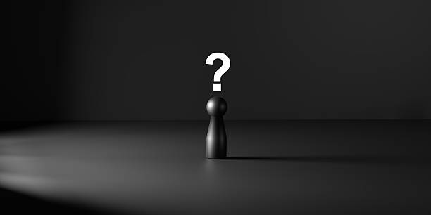 Black human like doll on dark surface with glowing question mark above, symbolizing uncertainty, doubt, mystery, unanswered questions, and existential problem solving.