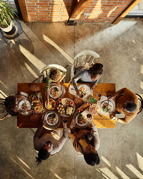 istock Above view of black extended family having lunch at dining table. 2225513844