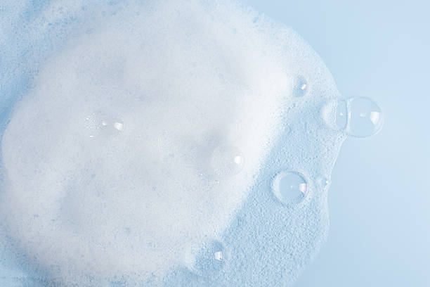 istock Chic white fluffy foam, soap foam texture with clear bubbles on blue background. A copy space. Layout for advertising detergent, spa cosmetics. 2225517572