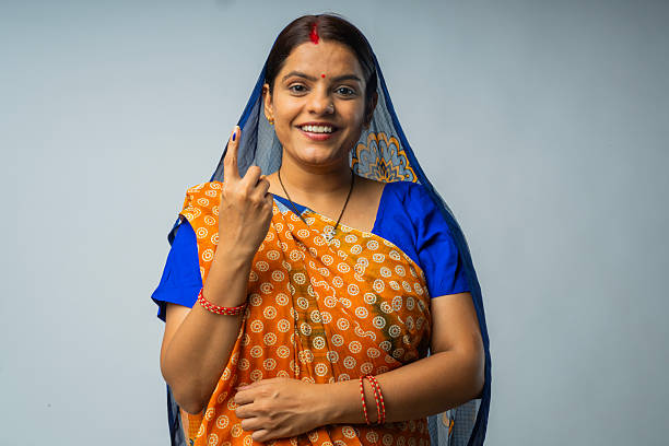 Young blonde fashion woman demonstrating traditional Indian saree.