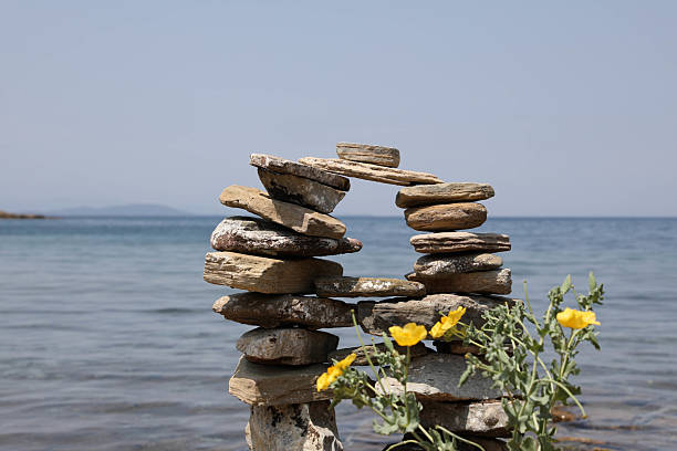 Stone bridge on beach with horizon over water