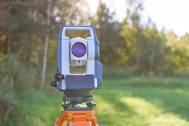istock A surveying instrument is standing in a field 2225520897
