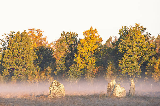 Stone circle a misty morning on a meadow at autumn