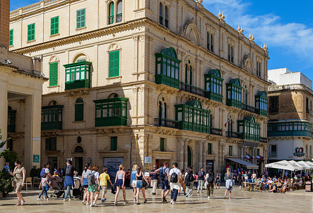 Old, densely stacked apartment buildings on narrow street, Valetta