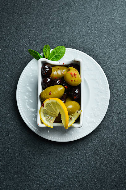 istock Olives in a white bowl. Appetizer. On a dark stone background. Free space for text. 2225530086