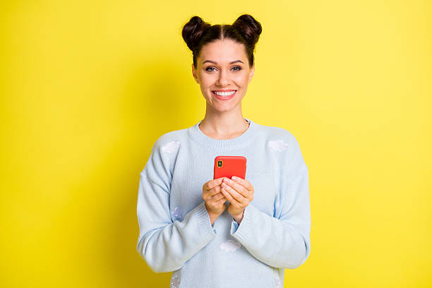 istock Portrait of attractive cheerful girl using device chatting  comment share feedback isolated over vibrant yellow color background 2225534399