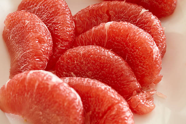 Red grapefruits on a plate, close-up, macro