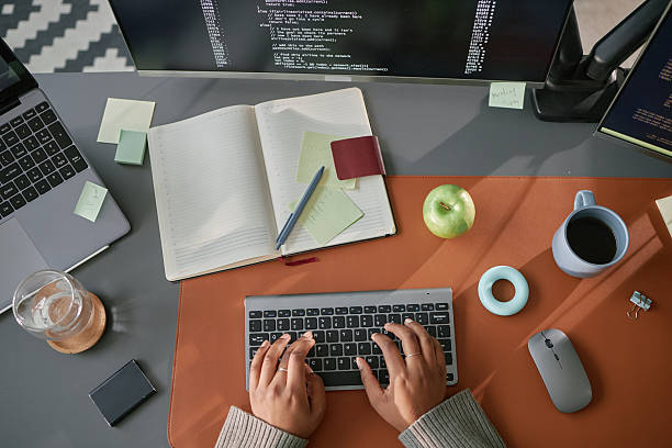 istock Young Adult Woman Typing Code on Wireless Keyboard at Modern Office Desk 2225534965