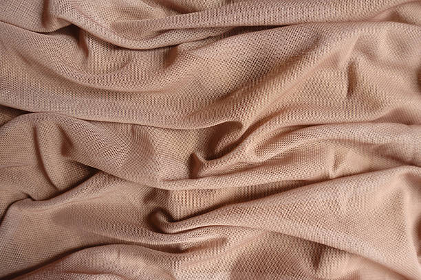 istock Background - pastel beige unprinted polyester mesh fabric in soft folds 2225536533