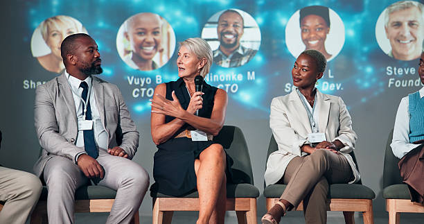 istock Business people, speaker and panel for audience, presentation and seminar for start up conference or convention. Woman, microphone and question for international trade show, event or workshop 2225548321