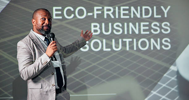 istock Business, black man and conference for climate change, presentation and microphone with speaker. Public speaking, expert and eco friendly seminar for solution, idea pitch and education forum 2225548400