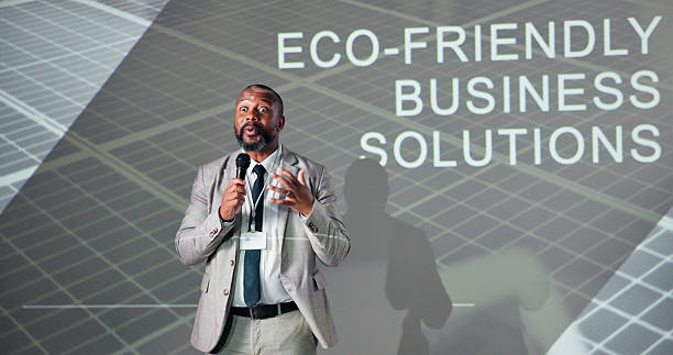 istock Business, black man or conference for presentation, speech or microphone with presenter. Public speaking, expert or climate change seminar for solution, idea pitch or education forum with convention 2225548414