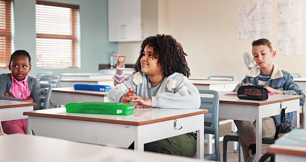 istock Classroom, students and listening for education, school and learning for young group in junior grade. Lecture, growth and children with knowledge, scholarship and development to prepare in academy 2225549254