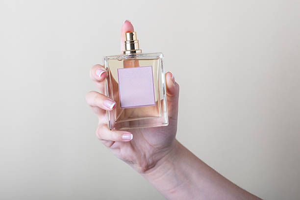 istock Woman holding a perfume bottle with blank label 2225549267