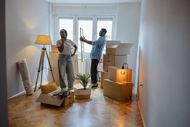 istock Couple arranging items in their new home during a moving day 2225549844