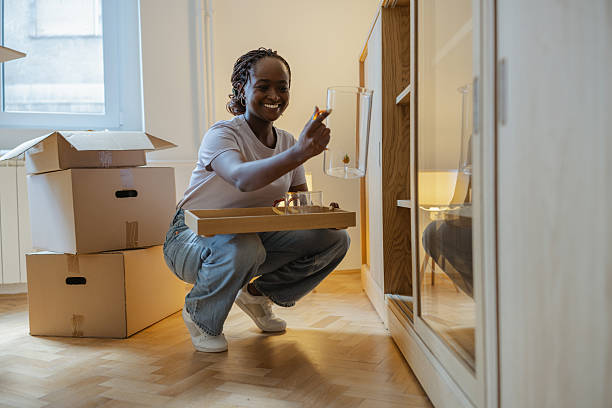 istock Woman unpacking household items from the boxes during a home relocation 2225550060