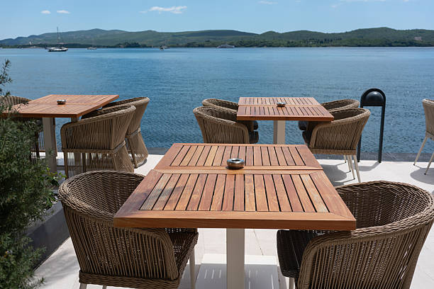 istock Wooden cafe tables with sea view 2225551495
