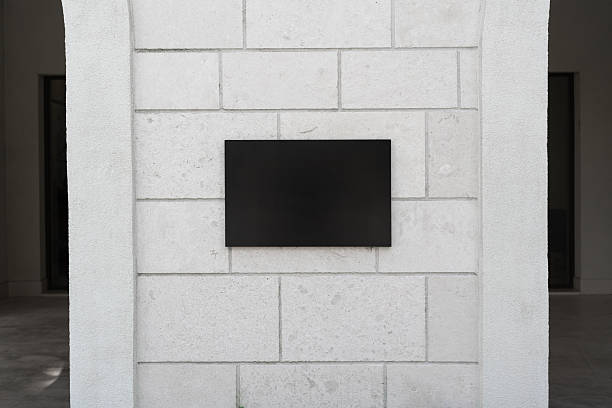istock Black sign on light concrete wall, empty copy space, mock-up 2225552393