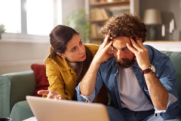 istock Worried couple discussing financial problems at home using laptop 2225553164