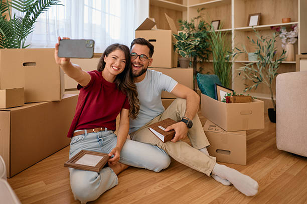 istock Young Couple Taking a Selfie While Unpacking in Their New Home 2225554087
