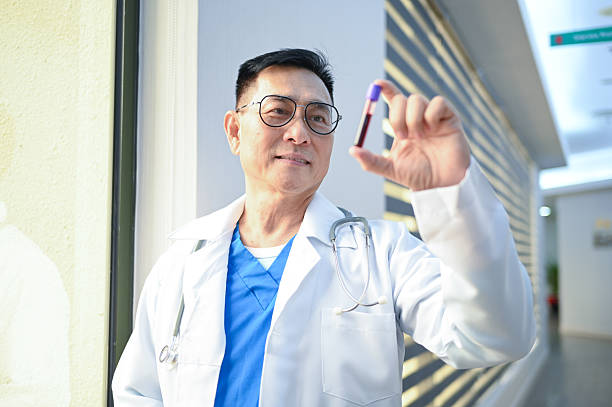 istock Focused Precision: A Doctor Examines a Blood Sample for Research 2225554926
