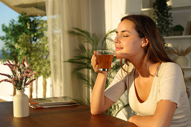 istock Woman at home relaxing smelling tea 2225558623