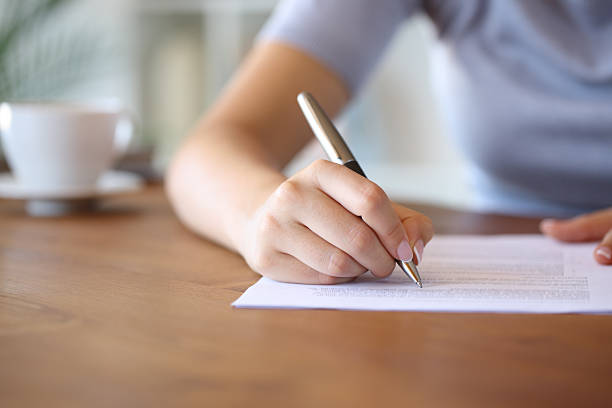 istock Woman hand writing on paper sheet 2225559056