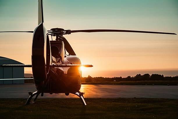 istock Backlit helicopter parked on airfield during sunset 2225559108