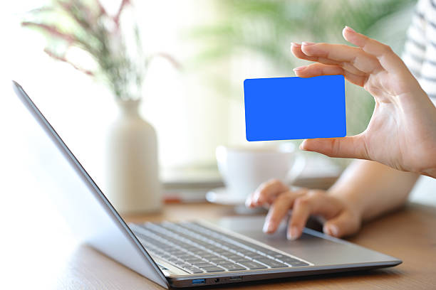istock Woman hand showing blank card using laptop 2225559525