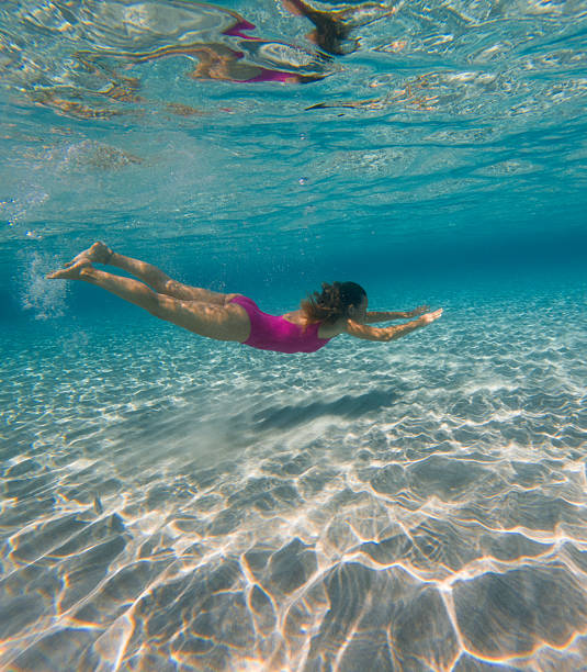istock Woman Swimming Underwater in Clear Ocean 2225560152