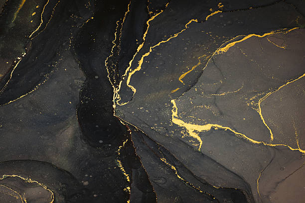 istock Abstarct fluid ink background with black and golden splashes 2225560537