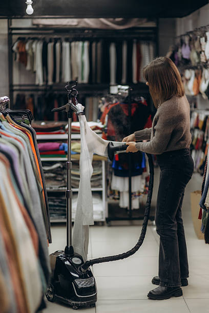istock Woman Steaming Clothes in a Boutique Using a Garment Steamer 2225561718