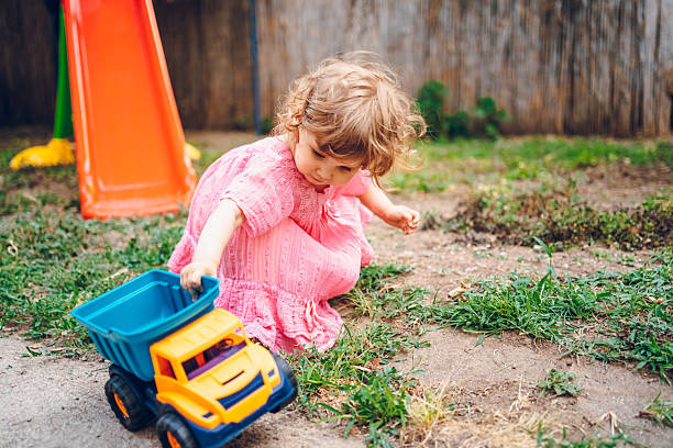istock A little girl is playing outside. 2225563848