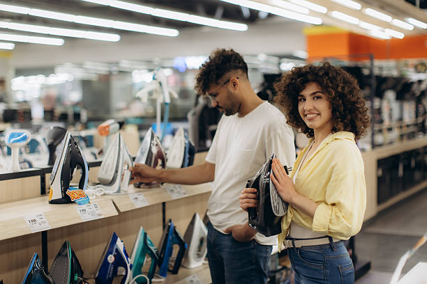 istock Smiling Couple Shopping for Household Irons in Electronics Store 2225565264