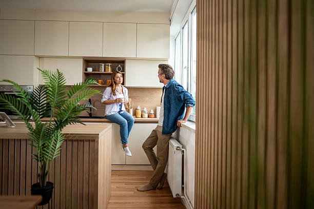 istock Couple enjoying morning coffee and conversation in modern kitchen 2225567859
