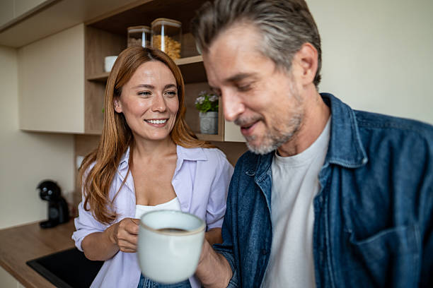 istock Happy couple enjoying morning coffee together in kitchen 2225567886