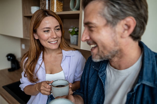 istock Happy couple enjoying coffee together in kitchen 2225567887