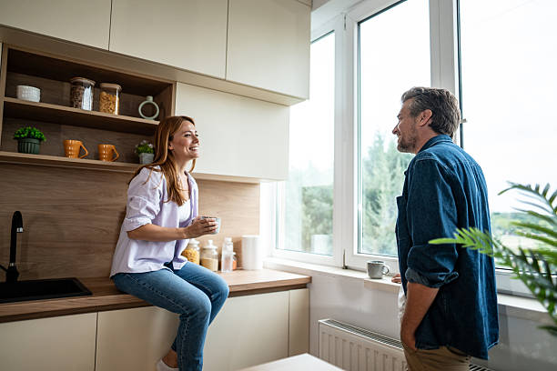 istock Happy couple enjoying a relaxing morning coffee in their modern kitchen 2225568019