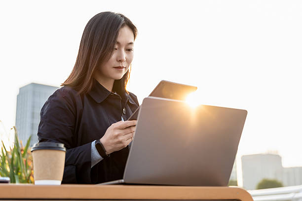 istock Professional woman working on a laptop in an outdoor setting 2225569792