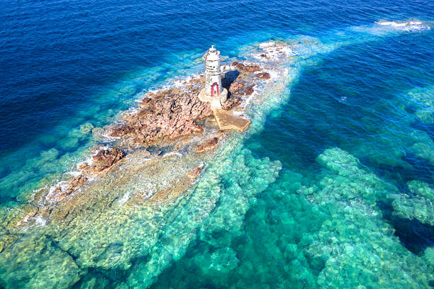 istock stunning lighthouse on a small stone island in the ocean 2225573987