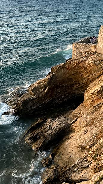 istock Rocky Coastline and Gentle Sea Waves – Tranquil Nature Background 2225577855