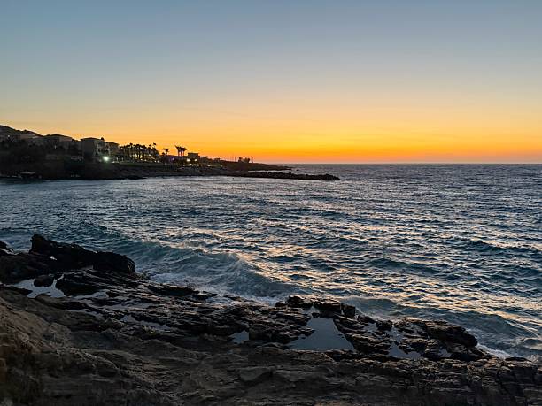 istock Rocky Shoreline at Sunset – Serene Ocean View with Waves 2225578435