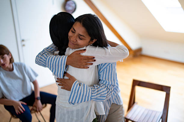 istock Two young women are hugging at a psychotherapy session 2225579062