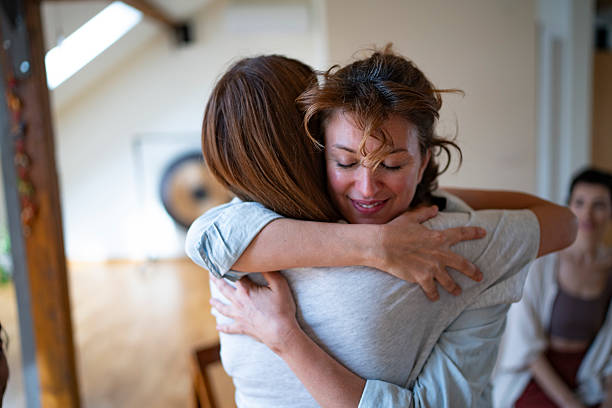 istock Two mid adult women hugging during therapy session 2225579074